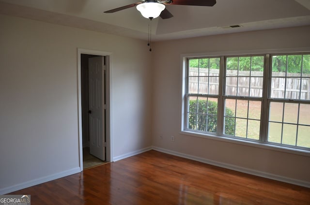 unfurnished room featuring ceiling fan, baseboards, and wood finished floors
