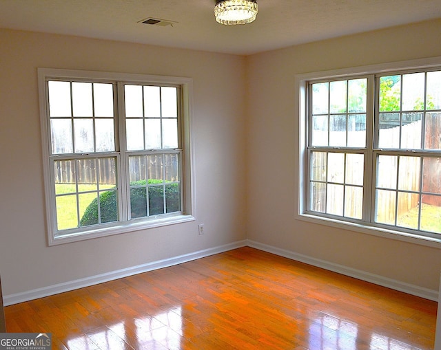 282 Ellesmere Ct, Buford, GA 30518 - empty room with wood finished floors and a chandelier