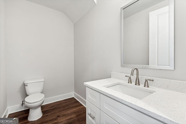 8210 Sonata Ln, Cumming, GA 30041 - half bath with baseboards, toilet, vanity, wood finished floors, and lofted ceiling