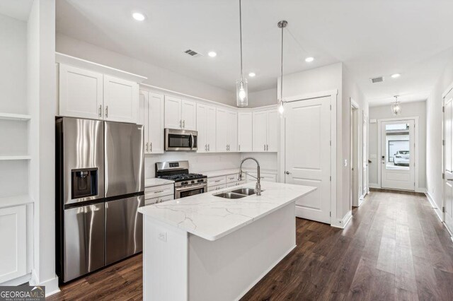 8210 Sonata Ln, Cumming, GA 30041 - kitchen with stainless steel appliances, a sink, white cabinetry, dark wood-type flooring, and recessed lighting