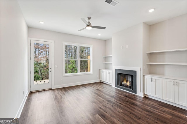 8210 Sonata Ln, Cumming, GA 30041 - unfurnished living room with a lit fireplace, dark wood-style floors, baseboards, a ceiling fan, and recessed lighting