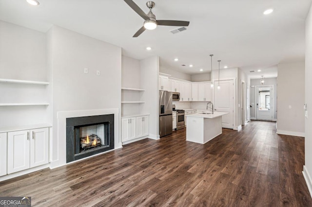 8210 Sonata Ln, Cumming, GA 30041 - kitchen featuring appliances with stainless steel finishes, a sink, built in shelves, a ceiling fan, and recessed lighting