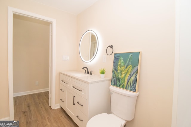 346 Grant Ave, Macon, GA 31201 - bathroom featuring wood finished floors, vanity, toilet, and baseboards