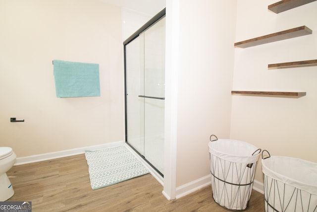 346 Grant Ave, Macon, GA 31201 - full bath featuring wood finished floors, a stall shower, baseboards, and toilet
