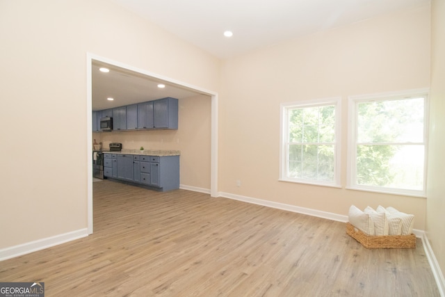 346 Grant Ave, Macon, GA 31201 - unfurnished living room with light wood-type flooring, baseboards, and recessed lighting