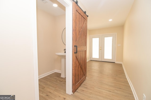 346 Grant Ave, Macon, GA 31201 - hall featuring a barn door, light wood finished floors, baseboards, and recessed lighting