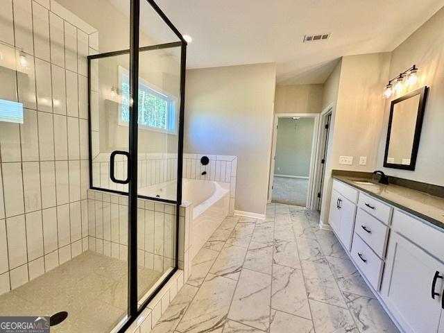 bathroom with marble finish flooring, a bath, a stall shower, and vanity