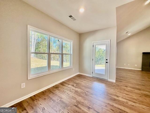 doorway to outside with plenty of natural light, baseboards, wood finished floors, and recessed lighting