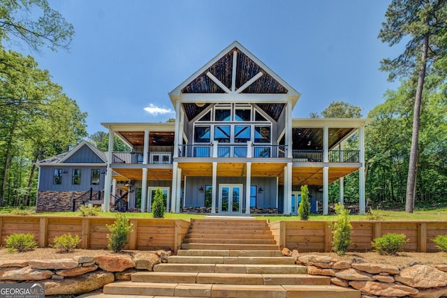 141G Lake Pines Rd, Jackson, GA 30233 - back of property with board and batten siding, stairs, french doors, and a balcony