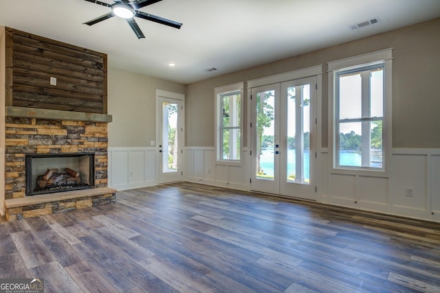 141G Lake Pines Rd, Jackson, GA 30233 - unfurnished living room featuring a decorative wall, wainscoting, a fireplace, wood finished floors, and ceiling fan