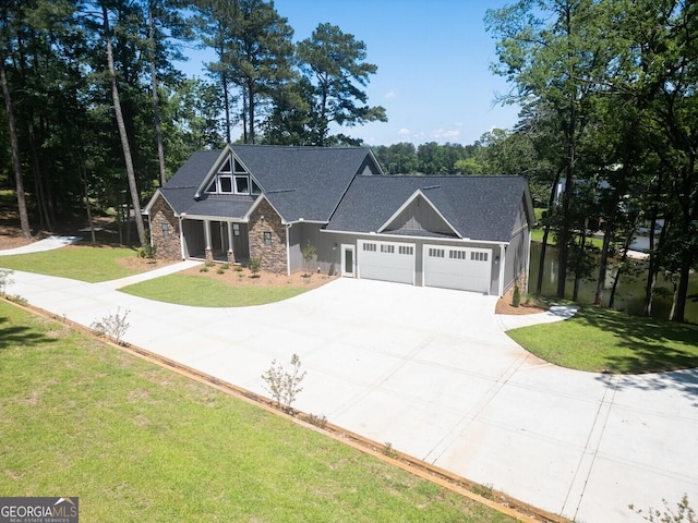 141G Lake Pines Rd, Jackson, GA 30233 - craftsman-style home with stone siding, driveway, a front lawn, and a garage