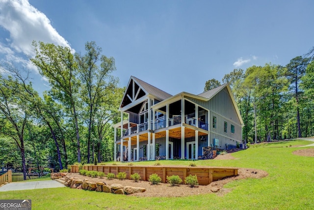 141G Lake Pines Rd, Jackson, GA 30233 - rear view of house featuring board and batten siding, a yard, and a deck