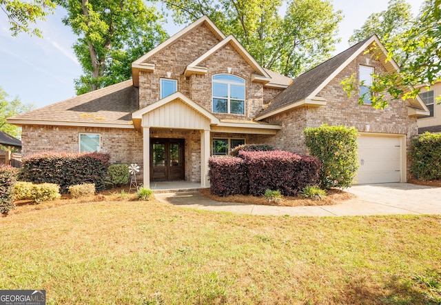 view of front of property with french doors, a front lawn, brick siding, and a shingled roof