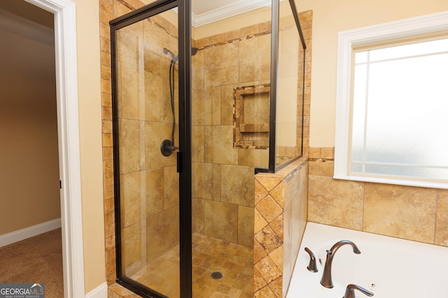 bathroom with a shower stall, a garden tub, and crown molding
