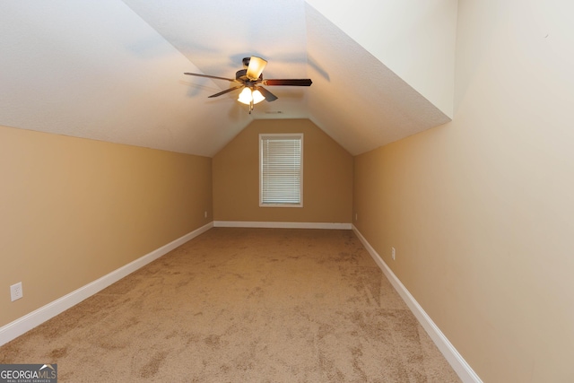 bonus room with carpet floors, lofted ceiling, ceiling fan, and baseboards
