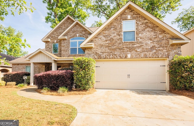 traditional home featuring brick siding, driveway, and an attached garage
