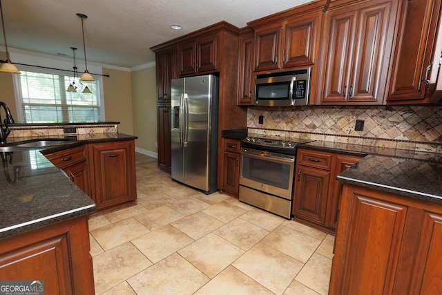kitchen featuring stainless steel appliances, a sink, backsplash, hanging light fixtures, and crown molding