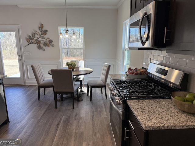 115 Vineyard Walk Lot 76, Carrollton, GA 30117 - kitchen with stainless steel appliances, dark wood-style flooring, dark cabinets, crown molding, and wainscoting