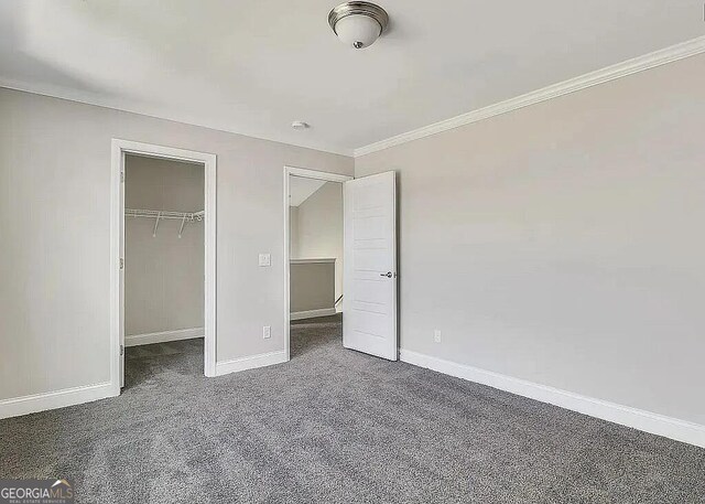 264 Harmony Blvd, Pooler, GA 31322 - unfurnished bedroom featuring carpet flooring, baseboards, crown molding, a spacious closet, and a closet