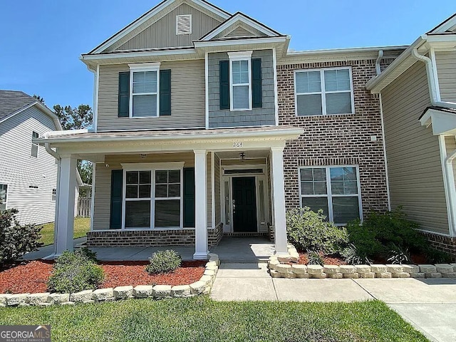 264 Harmony Blvd, Pooler, GA 31322 - view of front facade featuring covered porch, brick siding, and board and batten siding