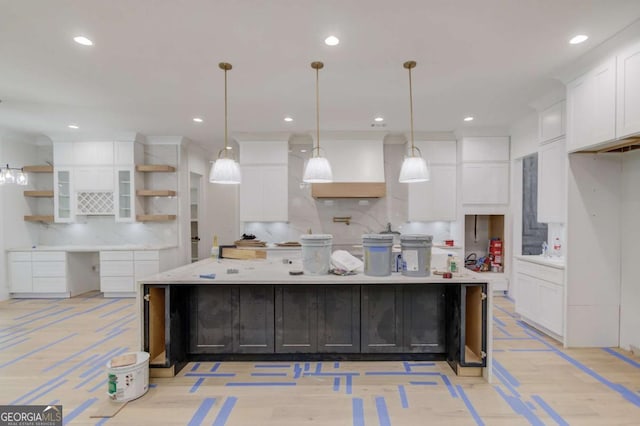 kitchen featuring open shelves, tasteful backsplash, white cabinetry, a large island, and light countertops