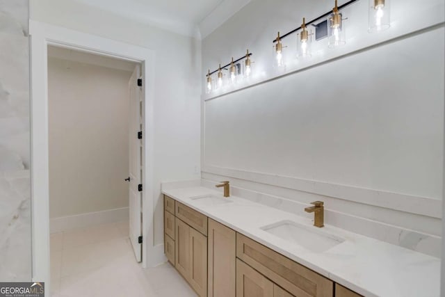 bathroom with tile patterned flooring, double vanity, and baseboards