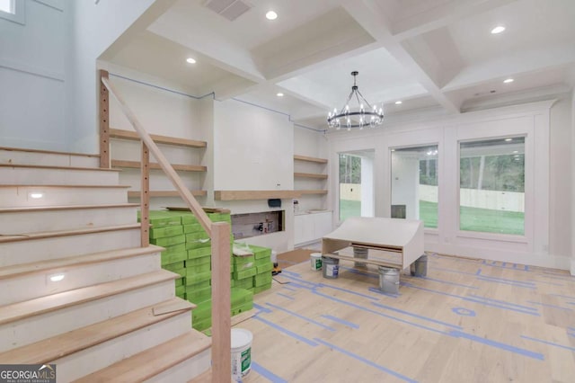 stairs with coffered ceiling, a chandelier, a fireplace, beam ceiling, and recessed lighting
