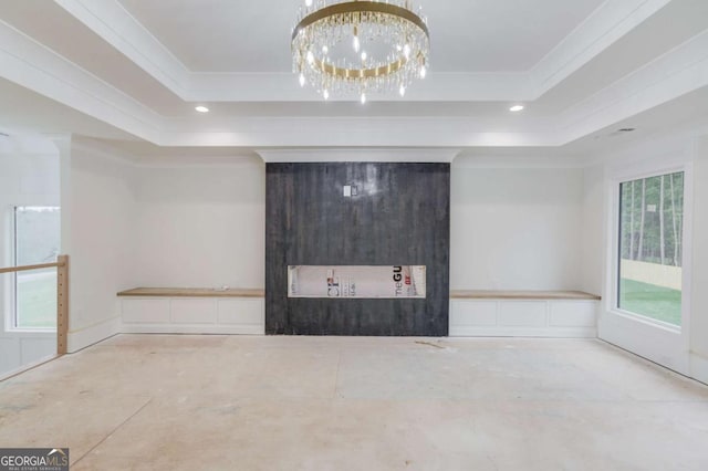 spare room with a tray ceiling, crown molding, recessed lighting, and a chandelier