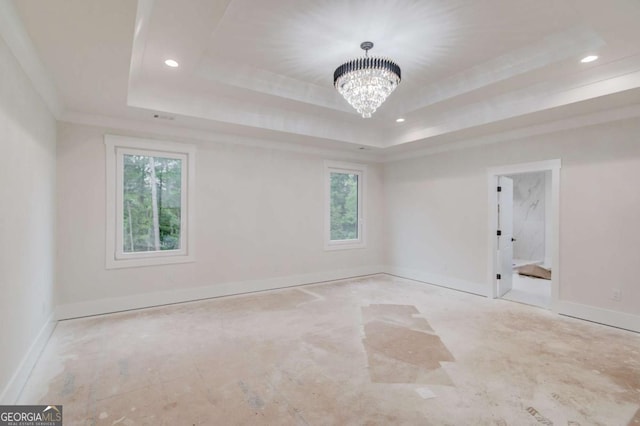 spare room with a tray ceiling, a chandelier, recessed lighting, and baseboards