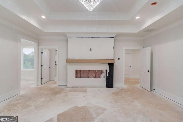 unfurnished living room featuring a tray ceiling, recessed lighting, and baseboards