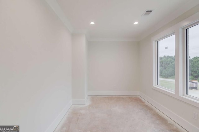 empty room featuring baseboards, recessed lighting, and crown molding