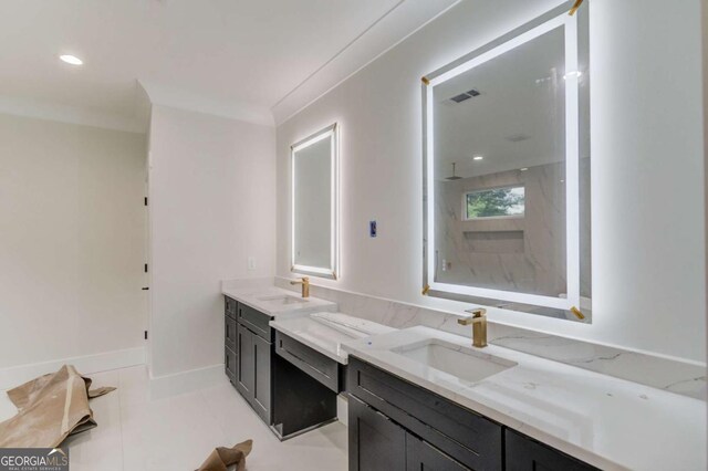full bath with a marble finish shower, two vanities, tile patterned floors, and recessed lighting