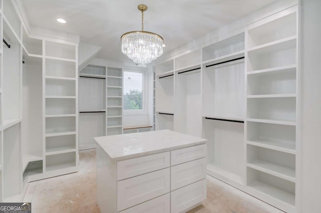 spacious closet featuring a chandelier