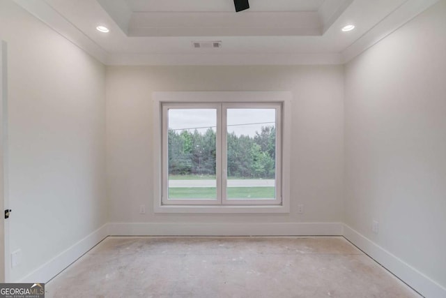 empty room with baseboards, recessed lighting, and a raised ceiling