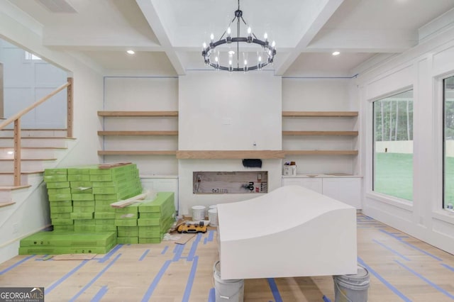 interior space featuring coffered ceiling, stairs, a chandelier, light wood-style floors, and beamed ceiling