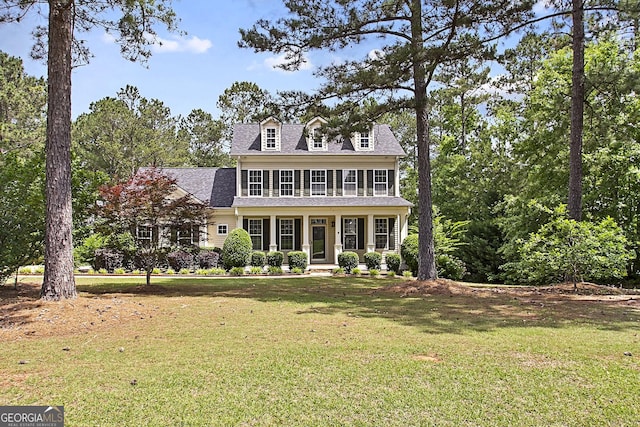 view of front of property with a front yard and a shingled roof