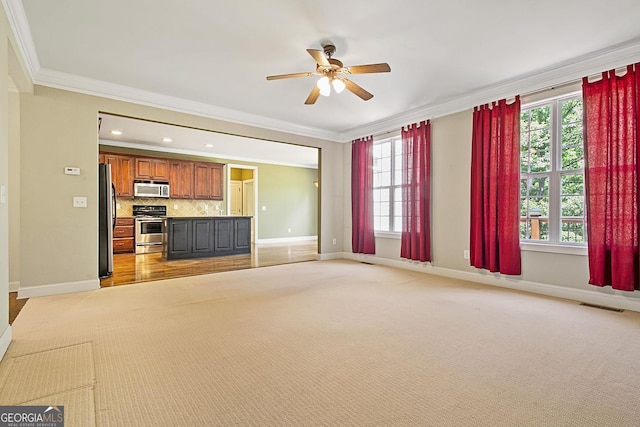 unfurnished living room featuring a ceiling fan, crown molding, plenty of natural light, baseboards, and recessed lighting