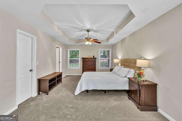 272 Blackberry Ln, Pendergrass, GA 30567 - carpeted bedroom featuring a tray ceiling and a ceiling fan