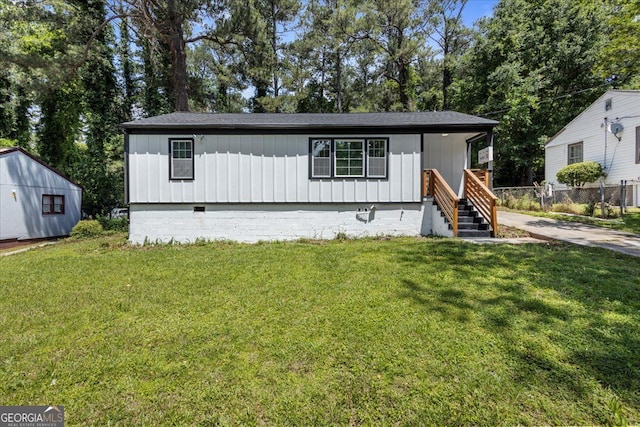 4134 Burgess Dr, Decatur, GA 30035 - view of front of house with crawl space, a front yard, and board and batten siding