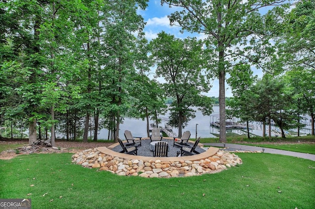 view of green lawn featuring a fire pit