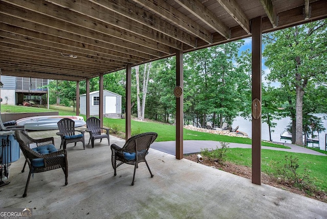 view of patio featuring a storage unit and an outbuilding