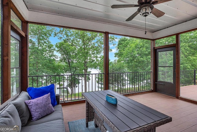 sunroom / solarium featuring a ceiling fan and healthy amount of natural light