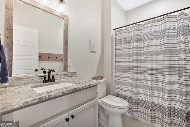 bathroom with vanity, toilet, and a shower with curtain