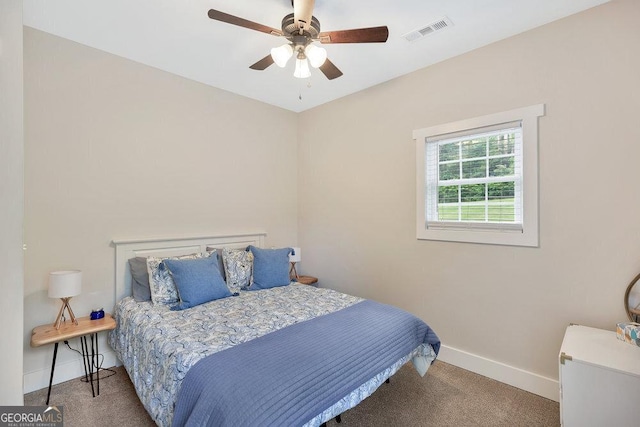 carpeted bedroom featuring baseboards and a ceiling fan