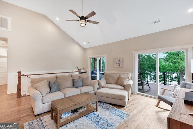 living area with light wood-style flooring, high vaulted ceiling, a ceiling fan, healthy amount of natural light, and recessed lighting