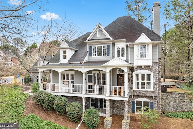 600 Lake Overlook Dr, Canton, GA 30114 - rear view of house featuring stone siding, a porch, a chimney, and a shingled roof