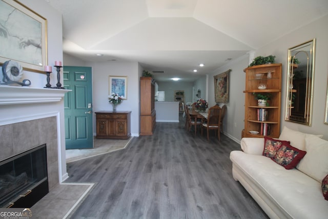 3024 Orchard Ridge Cir, Duluth, GA 30096 - living area featuring wood finished floors, lofted ceiling, recessed lighting, and a tiled fireplace