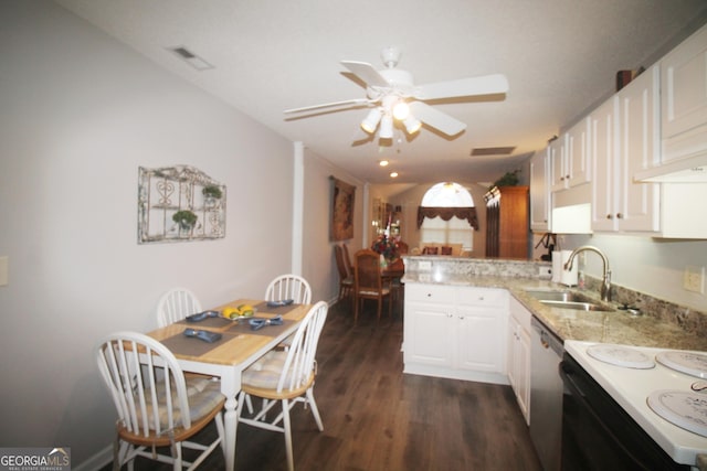kitchen with a sink, a peninsula, dishwasher, a ceiling fan, and dark wood-style flooring
