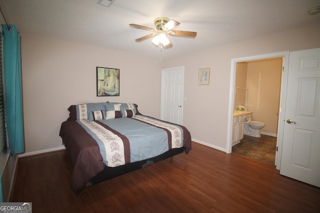 bedroom featuring wood finished floors, baseboards, ensuite bathroom, and ceiling fan