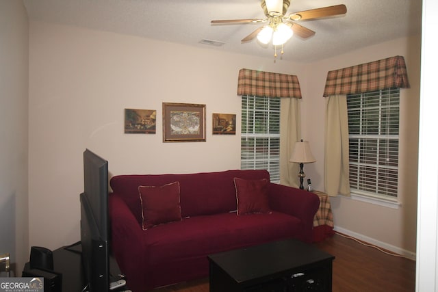 living room featuring ceiling fan, wood finished floors, and baseboards